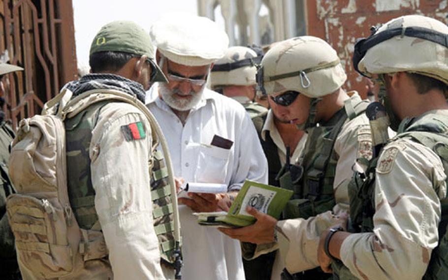 During a visit to a voter registration site in downtown Khowst, 2nd Lt. John Campbell (center) talks with Mujahedin about how the site was going. U.S. forces in Afghanistan last week launched Operation Lightning Resolve, a new campaign to protect the upcoming elections.