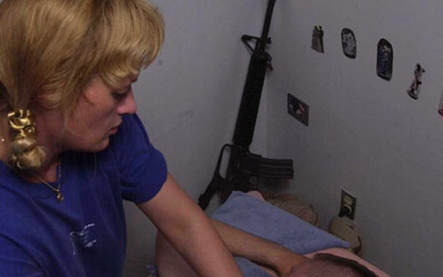 Spc. Christopher Cashell, a mechanic with 25th Infantry Division’s Aviation Brigade, enjoys a combat zone rubdown at the massage center at Bagram air base in Afghanistan.