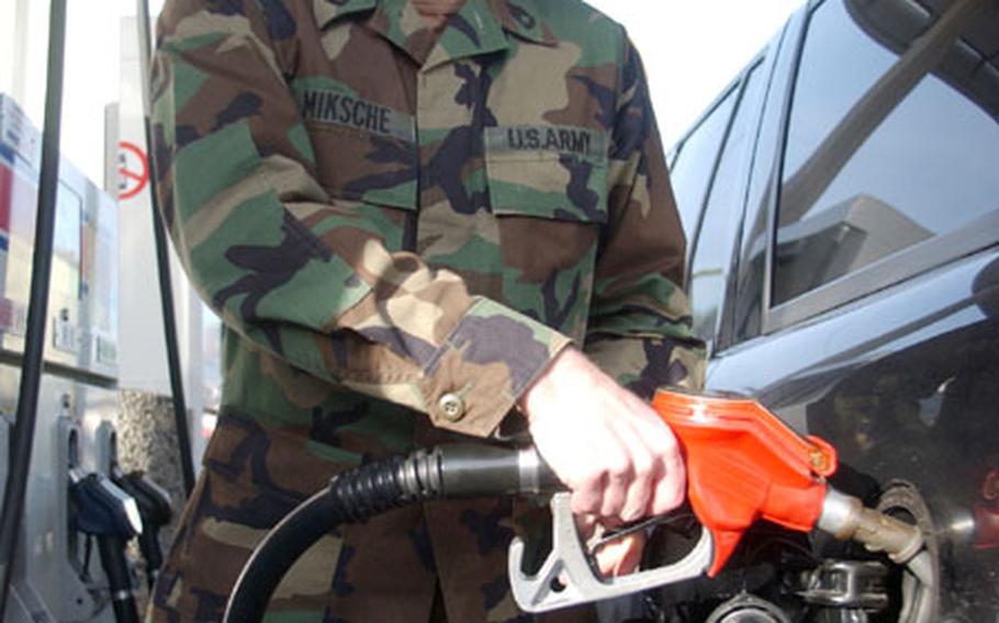 Sgt. 1st Class Mark Miksche fills up his car at the AAFES gas station in Lincoln Village military family housing in Darmstadt, Germany, on Tuesday.