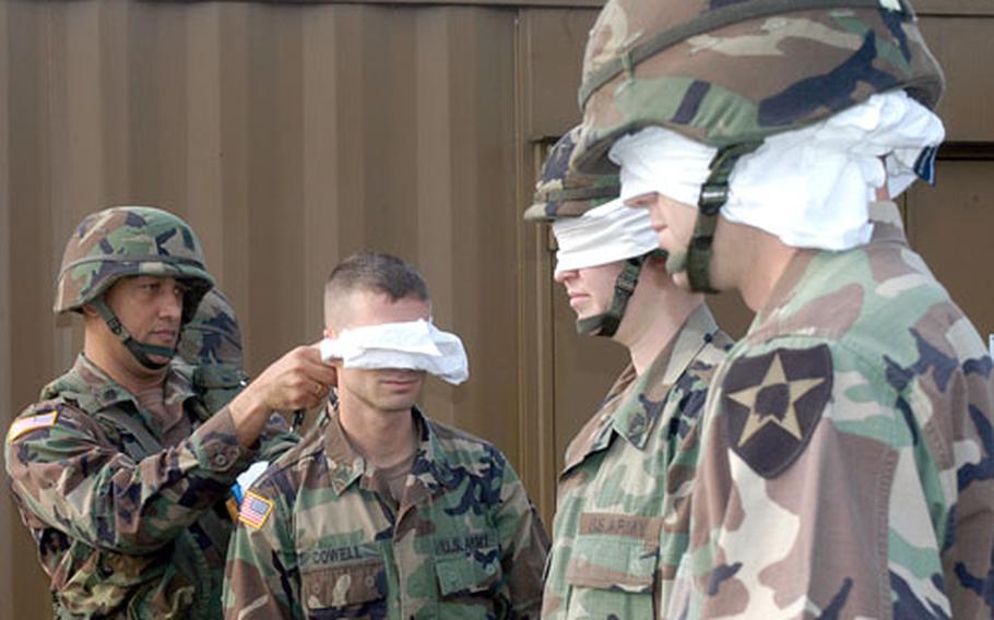 Soldiers being blindfolded before undergoing one of the many field tests that were part of last week's competition for 8th U.S. Army soldier, noncommissioned officer and KATUSA of the year awards. KATUSAs are Korean Army soldiers assigned to the U.S. Army. The weeklong event ran from July 12 to July 16 at and near Camp Humphreys, South Korea, culminating with an awards dinner in Seoul.