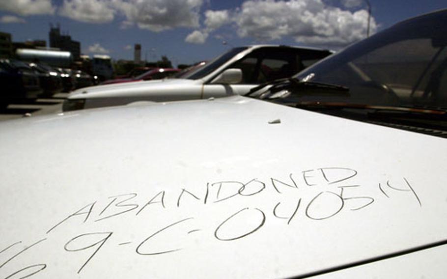 An abandoned car sits in the Joint Services Vehicle Impound Lot on Camp Kinser among other vehicles illegally dumped by their owners when they left Okinawa. Those who don't properly sell or scrap their vehicles when they leave will pay fines and fees eventually through either a pay check deduction or out of their Income Tax refund.