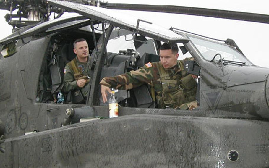 Chief Warrant Officer 2 Mike Sauer (left) and Chief Warrant Officer 3 George R. Kessler piloted one of the 2nd Squadron, 6th Cavalry Regiment's first 10 AH-64D Apache Longbow helicopters home to Illesheim Army Airfield, Germany, Monday.