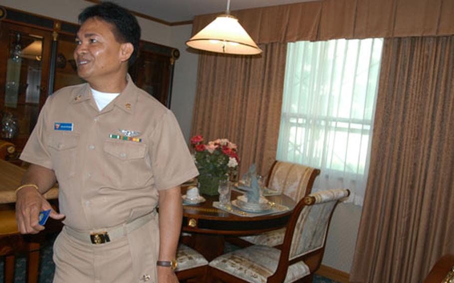 Senior Chief Petty Officer Pedro Magistrado, the combined bachelor housing officer at Naval Air Facility Misawa, visits one of five distinguished visitor rooms at the base's Navy lodging. NAF Misawa recently earned the Admiral Elmo R. Zumwalt Award for Excellence in Bachelor Housing Management. It's the fifth consecutive time the command has been named for the award.