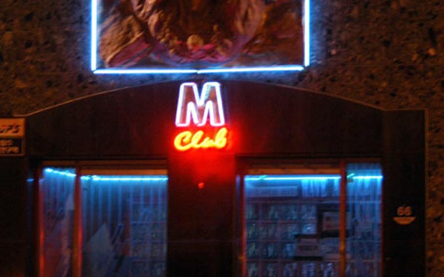 The M-Club in Toka-ri, South Korea, is one of many bars and brothels displaying 2nd Infantry Division symbols, such as a huge Indianhead — the division's logo — above the door.