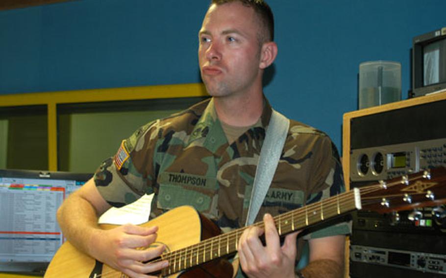 Staff Sgt. Joe Thompson, AFN Hessen noncommissioned officer in charge, jams out on his guitar in the radio studio Thursday in Wiesbaden, Germany. GI Joe, as he's known on the air, has been playing guitar for over ten years and is regular entertainment at a German pub near Frankfurt.