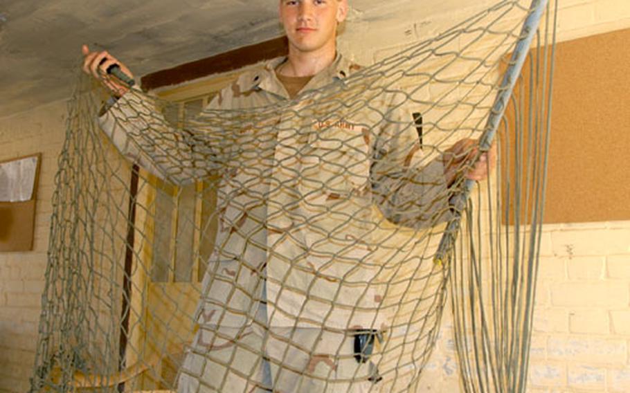 Spc. Charles Copp shows the hammock he’s been making since he arrived at Forward Operating Base Gabe in Baqouba, Iraq, in March. Copp, the go-to guy for repairs in Battery C, 1st Battalion, 6th Field Artillery Regiment, adds several inches to the hammock at a time “whenever I get bored,” he said. He also crafts watch, radio and knife handles made out of 550 cord and said he gets many requests for these items from other soldiers in his unit.