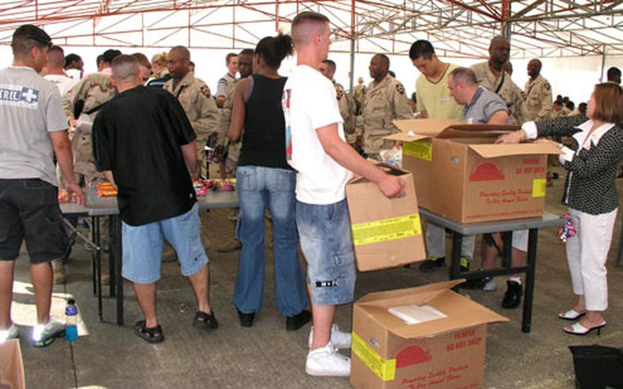 Volunteers at Osan Air Base help the staff at a Red Cross canteen set up to provide physical comfort and encouragement to troops of Army's 2nd Infantry Division as they prepare to leave for the Middle East.