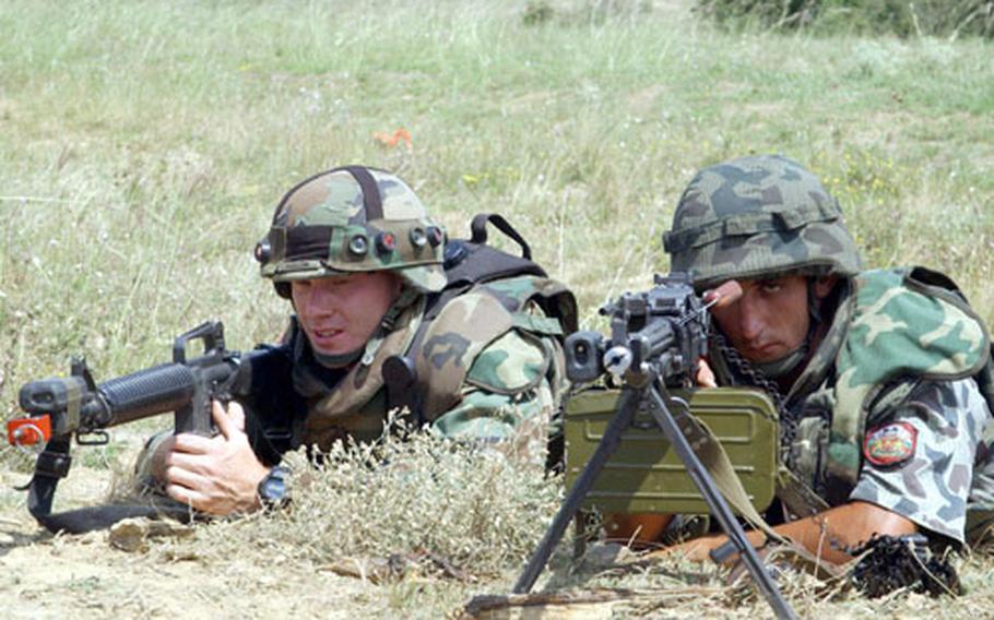 Staff Sgt. Jeremy Wenthe, left, and Bulgarian soldier Pvt. Atanas Kovachev train side by side during a Multi Operations Urban Training exercise Wednesday at the Novo Selo Training Area, Bulgaria. Twenty-two Bulgarian troops trained with U.S. soldiers during the Bulwark '04 exercise.