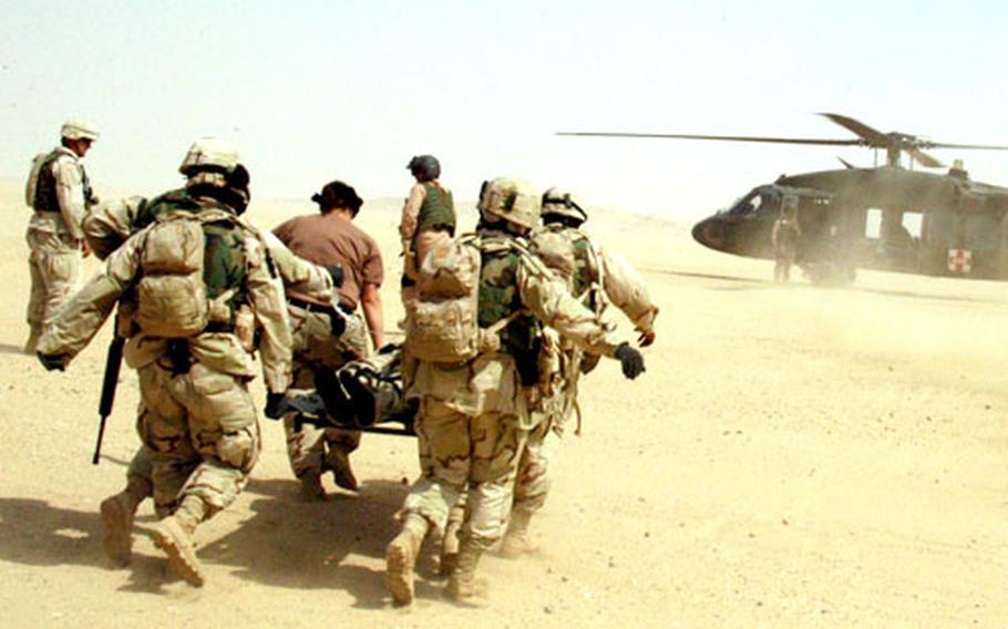 2nd FSB soldiers carry a solider later diagnosed with a bronchial condition to a medevac helicopter at Udairi Range on Sunday.