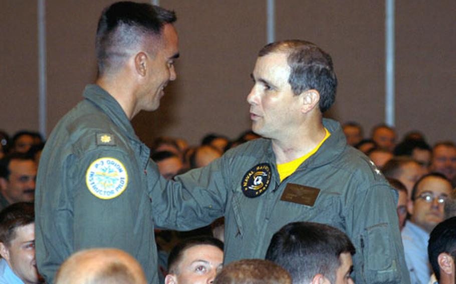U.S. Navy Lt. Cmdr. Andrew Westerkom, commander of VP46 from Whidbey Island Naval Air Station and currently deployed to Misawa Naval Air Station, is quizzed on safety procedures by Rear Admiral Richard E. Brooks, Commander Naval Safety Center, during a safety briefing in Misawa on Tuesday. Brooks spoke to the Navy population of Misawa about the prevention of recreational casualties.