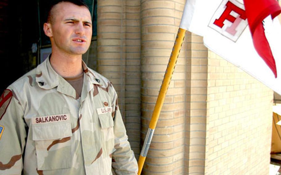 Staff Sgt. Adin Salkanovic of F Troop, 9th Cavalry, in front of the unit's headquarters at Camp Grey Wolf in Baghdad's International Zone.