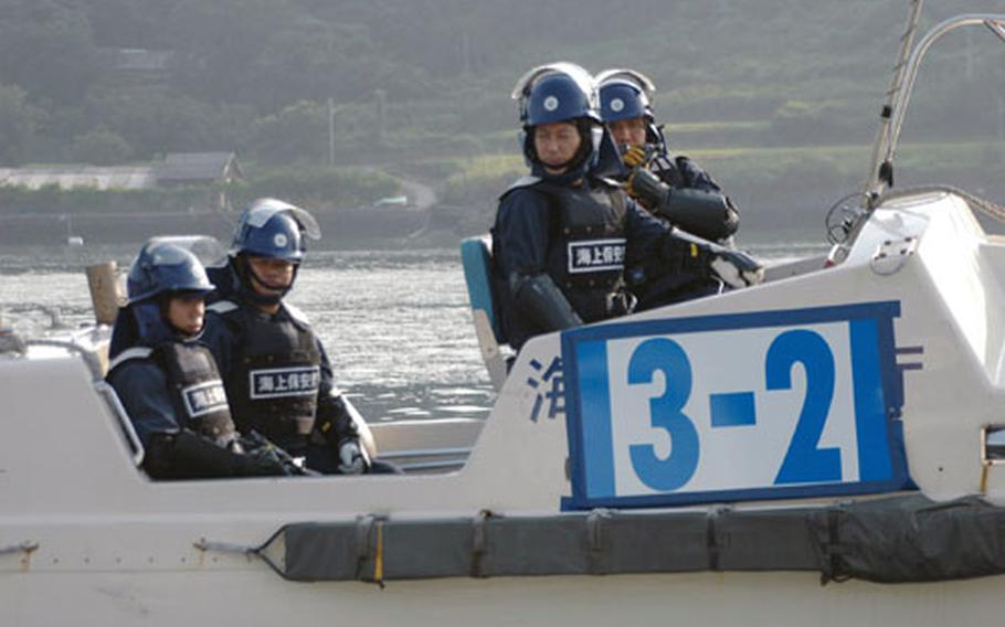 Japanese riot police were present in small boats just in case things got out of hand as about 150 Japanese protesters rode in about 20 fishing boats and shouted in megaphones to express their disapproval of the USS John C. Stennis' port call at Sasebo Naval Base on Saturday. The protest was loud, but peaceful.