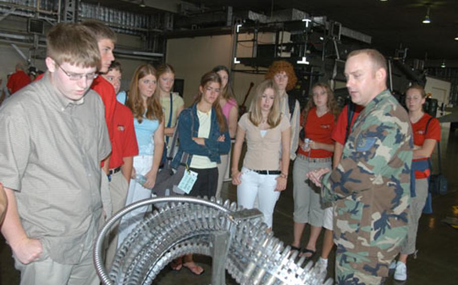 Tech. Sgt. Chance Nichols, a lead standardization crewmember with 35th Maintenance Group at Misawa Air Base, Japan, shows students from Wenatchee, Wash., ammunition for an F-16. A delegation of students, parents and civic leaders from Wenatchee, Misawa's sister city, visited Misawa last week, stopping by the base Friday for a tour and lunch.