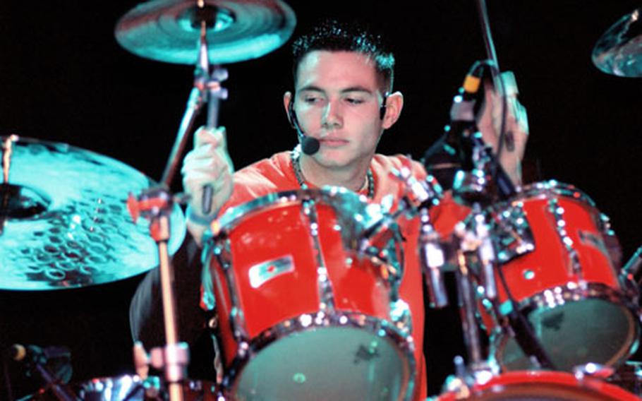 Jed Martin, drummer for the Hohenfels, Germany-based band Busted Amber, shows off some of the skills that won him "best drummer" at the U.S. Army Europe's annual Battle of Bands held Saturday in Katterbach, Germany.