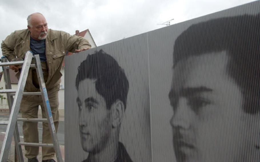 Herbert Schaefer puts the finishing touches Tuesday on a monument honoring seven U.S. airmen killed by a mob in Rüsselsheim, Germany, during World War II.