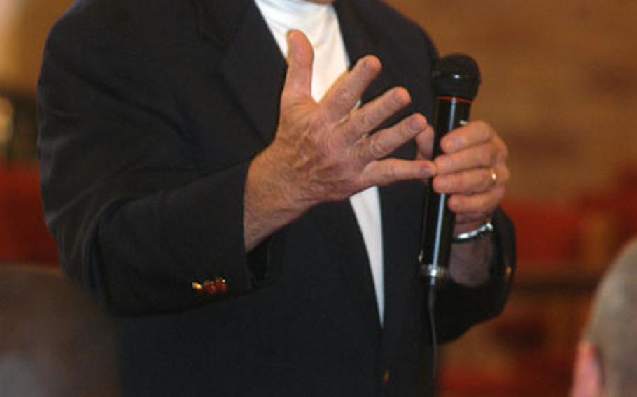 Retired Chief Master Sgt. of the Air Force Robert Gaylor, 74, speaks Friday to a packed house at the base chapel on RAF Mildenhall, England. Nearly 300 airmen listened to Gaylor's motivational talk, sprinkled with memories and humor.