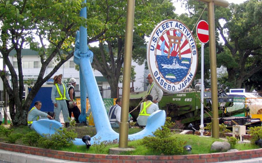 Workers at Sasebo Naval Base spent Saturday making sure that anything that could be a hazard when blown about by a typhoon is secured. Benches, garbarge receptacles and free-standing gazebos were lashed down.