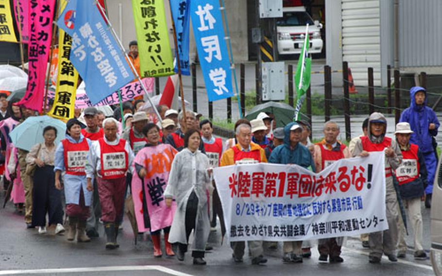 Japanese protestors, demonstrating in opposition to unconfirmed reports of Army troop movement plans, march together from Sobudaimai Train Station to Camp Zama's Main Gate Sunday.