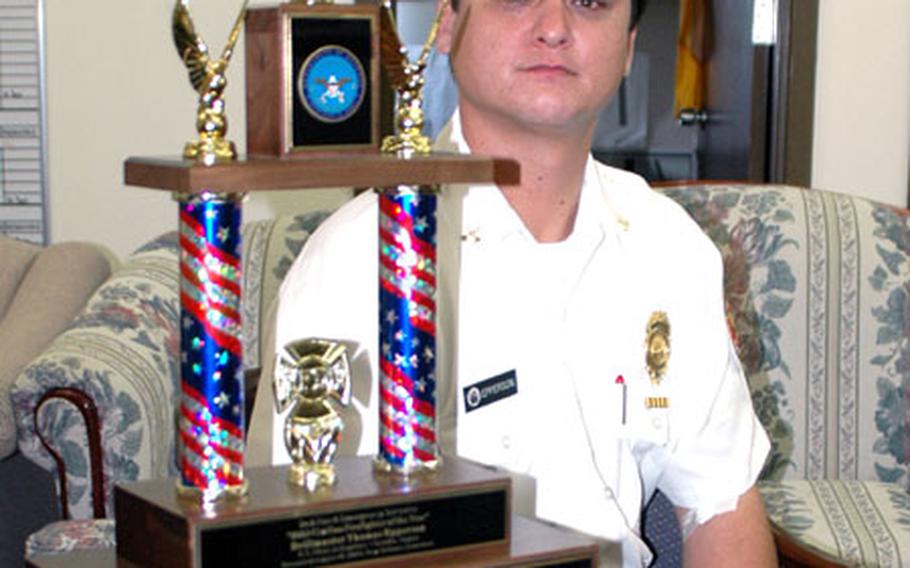 Officer Thomas Epperson, drillmaster of Sasebo Naval Base's Command U.S. Naval Forces Japan Regional Fire Department, won the U.S. Navy's Civilian Firefighter of the Year award in July. On Aug. 18, while in New Orleans to receive the Navy award, the surprised Epperson as also named the Department of Defense Civilian Firefighter of the Year from among the estimated 13,000 employed by DOD. Epperson is shown at the Sasebo office with his trophy.