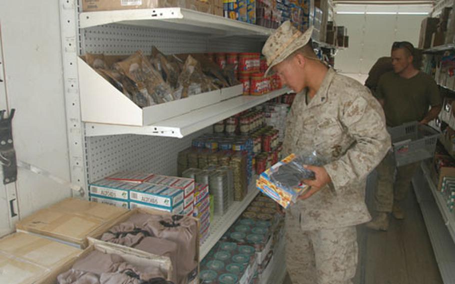 Cpl. Gee Vue of Marine Service Support Group 11 shops at the Camp Duke, Iraq, post exchange on Wednesday. Vue and a few other Marines and soldiers helping to open the exchange were able to shop before Friday's planned opening.