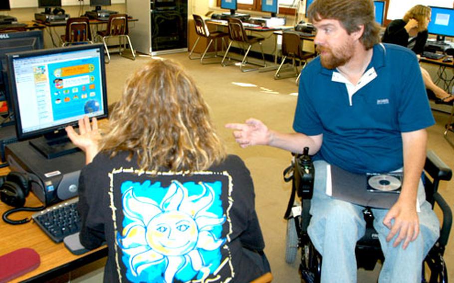 Pam Baker, left, and Parrish Worrell discuss portions of a class that they were to present to teachers of kindergarten through second-grade students at Bamberg Elementary School.