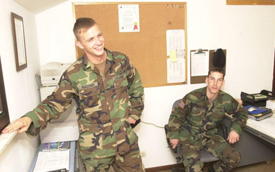 Spc. Joshua Reasoner, left, and Staff Sgt. Eric Knott talk about their time at war while relaxing at Knott's office at battalion headquarters.