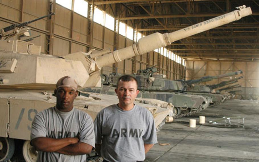 Pfc. Stanley Cuffee, left, an ammunition loader with 2nd Battalion, 72nd Armored Regiment, and Sgt. David Olansoto, a gunner with the regiment, transferred to a new tank after an attack that killed their commander, Staff Sgt. Gary Alexander Vaillant, on Sunday.