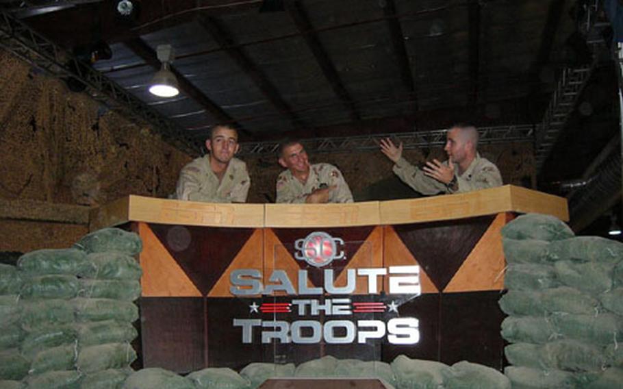 From left, Pvt. Camron Craw, Spc. Michael Curtis and Spc. Lucas Monahan, act out their own version of ESPN's SportsCenter as they were working to build the set last Thursday. Dozens of soldiers took part in creation of the studio and ESPN offices for SportsCenter's live broadcasts next week. Craw, from Minersville, Utah, is assigned to the 32nd Transportation Company; Curtis, from Miami, is assigned to the 50th Area Support Group, and Monahan, from Andalusia, Ala., is assigned to the 175th Maintenance Co.