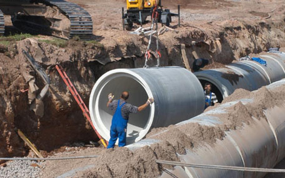 Workers lay drainage pipe at the west end of Ramstein Air Base's runway in a 15-foot trench Air Force officials called "the big ditch." The ditch is part of a $2 million project to repair the runway.