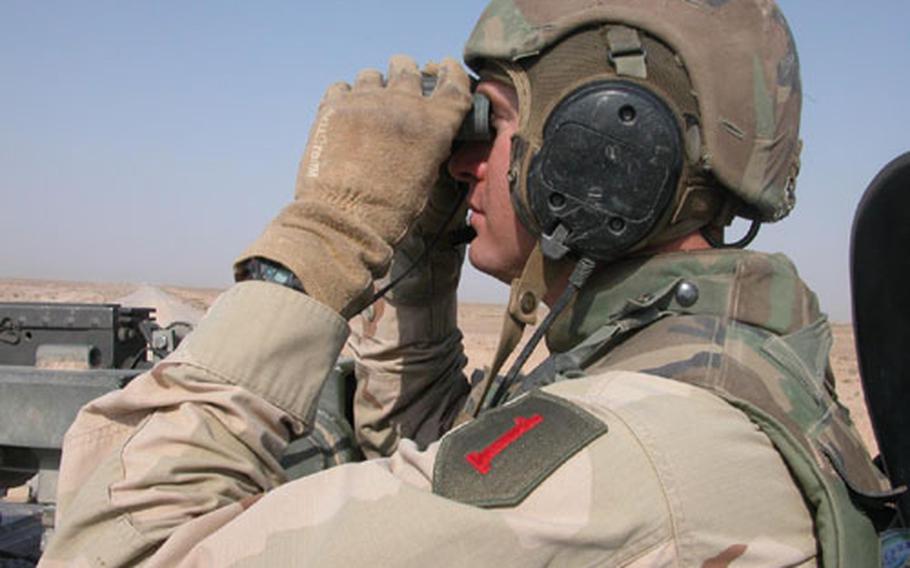 Capt. John Trylch, commander of the 1st Squaron, 4th Cavalry’s Troop B, from Schweinfurt, Germany, scans for suspicious activity while on a recent mission to clear a route that the Army calls Grape, considered among the most dangerous roads in Iraq.