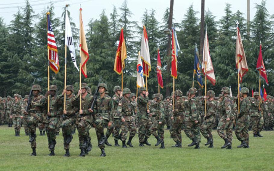 Soldiers bearing colors of units within the Army's 19th Theater Support Command execute drill maneuvers during Friday morning's unit change-of-command ceremony at Camp Walker in Taegu, South Korea. Maj. Gen. Jeanette K. Edmunds completed a two-year assignment as 19th TSC commander and moves to a key Pentagon logistics assignment. The unit's new commander is Brig. Gen. Timothy P. McHale.