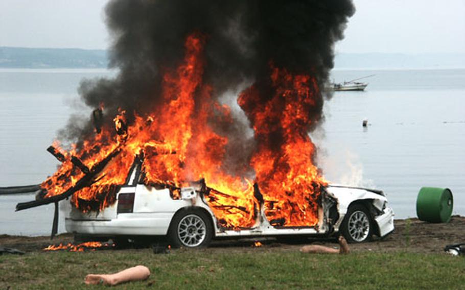 A parked car burns at a beach Friday as part of a weapons of mass destruction exercise at Misawa Air Base, Japan. The exercise tested the 35th Fighter Wing's ability to respond to WMD incidents as part of the Air Force Weapons of Mass Destruction Installation Training and Exercise Program.