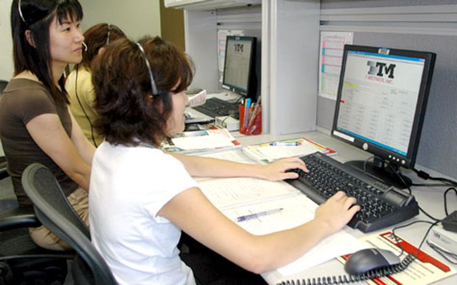 Operators Harumi Todaka and Mayumi Fujiyama answer calls Monday at the Navy Japan Telephone Operator Center at Sasebo Naval Base. Callers seeking an operator’s assistance when they dial from Sasebo, Yokosuka Naval Base or Atsugi Naval Air Facility, end up speaking to an operator working here. In addition, Sasebo will soon be handling Guam Navy telephone operator services.