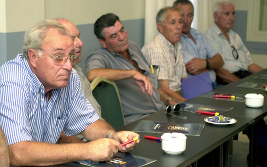 Retired U.S. Navy ship workers who were exposed to asbestos during the 1950s, '60s and '70s listen to attorney Mitchell Cohen at Hotel Playa de la Luz in Rota, Spain, on Tuesday.