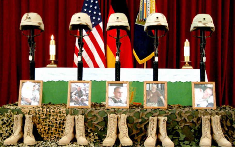 Helmets, rifles, dog tags, photos and boots of Sgt. Robert E. Colvill, Spc. Collier E. Barcus, Spc. Joseph M. Garmback Jr., Spc. William R. Emanuel IV and Spc. Sonny G. Sampler stand in front of the Ledward Barracks chapel altar at a July 14 memorial service for the soldiers in Schweinfurt, Germany.