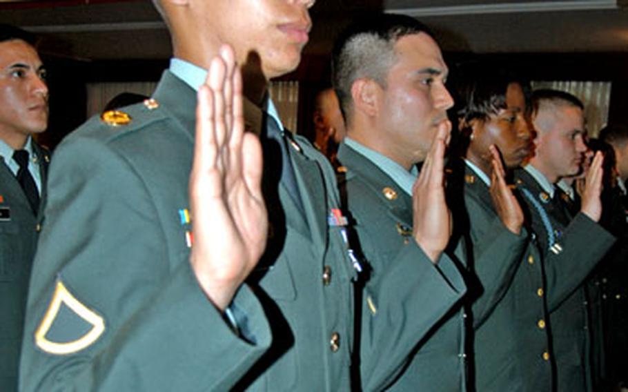 Pfc. Jorge Latorre, foreground, and 27 other servicemembers became U.S. citizens on Wednesday. Latorre is from Cuzco, Peru.