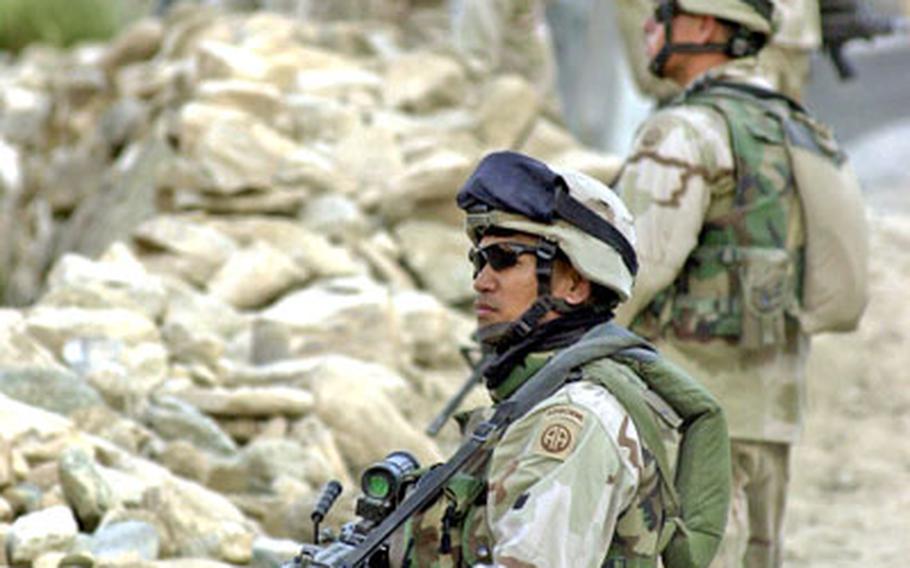 Sgt. Elizar Russell heads up a line of soldiers searching the mountains for attackers as Humvees from the 82nd Airborne Division’s 1st Battalion, 505th Parachute Infantry Regiment’s Company B try to turn around, stopping three kilometers short of the Pakistan border.