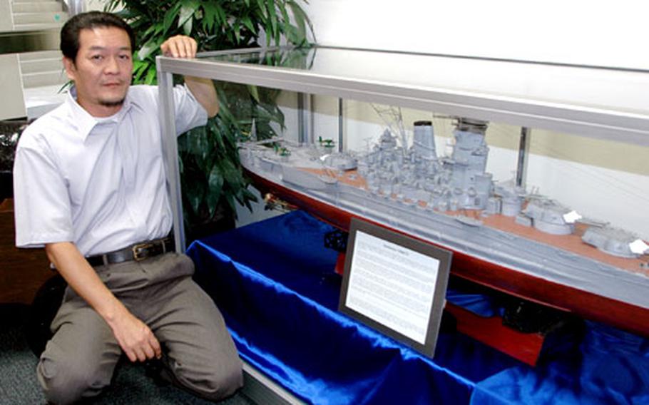 Fumio Osako, an employee with Sasebo Naval Base’s Public Works Division, is shown with a model of the Japanese Imperial Navy’s Yamato battleship he built. The Sasebo Naval Base Museum is exhibiting the model of the Yamato, the largest battleship in the world when U.S. submarines sank the vessel in 1945. The model is 6 feet long and made entirely from scrap — primarily disposable wooden chopsticks. Osako took about one year to build the model, using photographs and drawings of the ship as a guide.