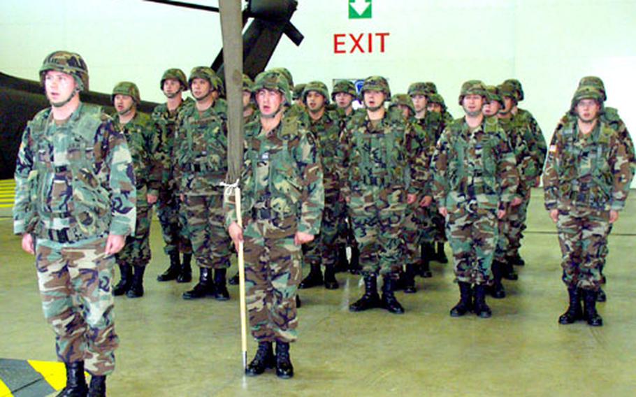 The assembled soldiers of Company C, 5th Battalion, 158th Aviation Regiment, sing the Army song one last time at the unit’s deactivation ceremony in Giebelstadt, Germany.