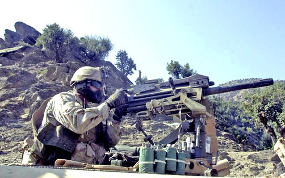 Special forces teams, not conventional units, do most of the fighting in remote areas. Here, a MK-19 gunner rakes a hillside with 40-mm grenades during fighting in the mountains of eastern Afghanistan.
