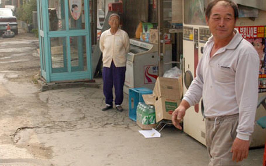 South Koreans Kim In-Nae, left, and Kang Yong-I live and work near the former U.S. base that inspired “M*A*S*H,” but neither have heard of the book, film or television series.