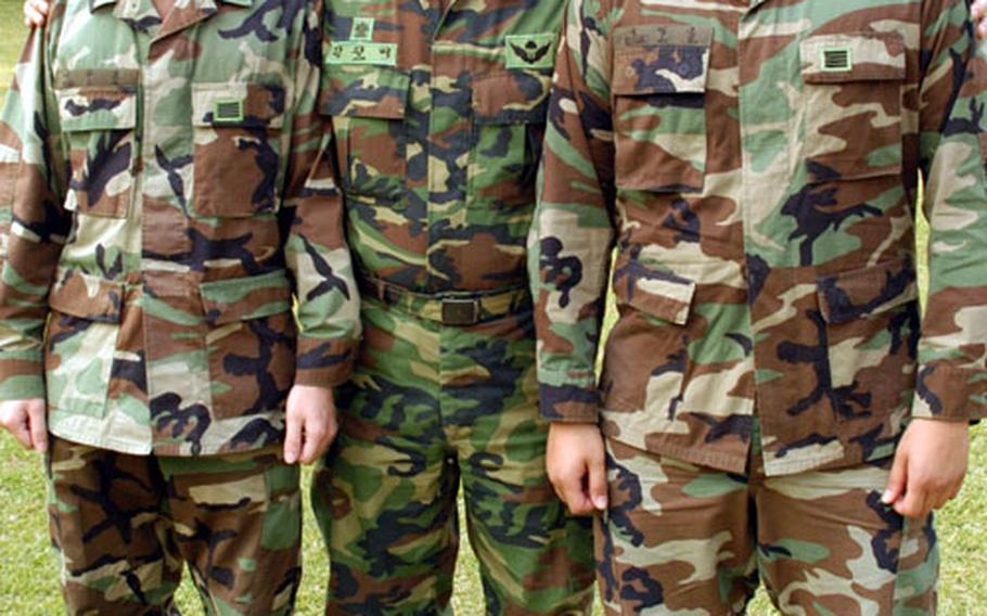 Capt. Kim Jung Pae, center, of Seoul, the 33-year-old Republic of Korea Army staff liaison officer assigned to the 2nd Infantry Division, stands with two former 2nd Brigade KATUSAs, Sgt. Yuh Joon Ho, 23, of Pusan, left, and Sgt. Kook Jung Hoon, 25, of Seoul.