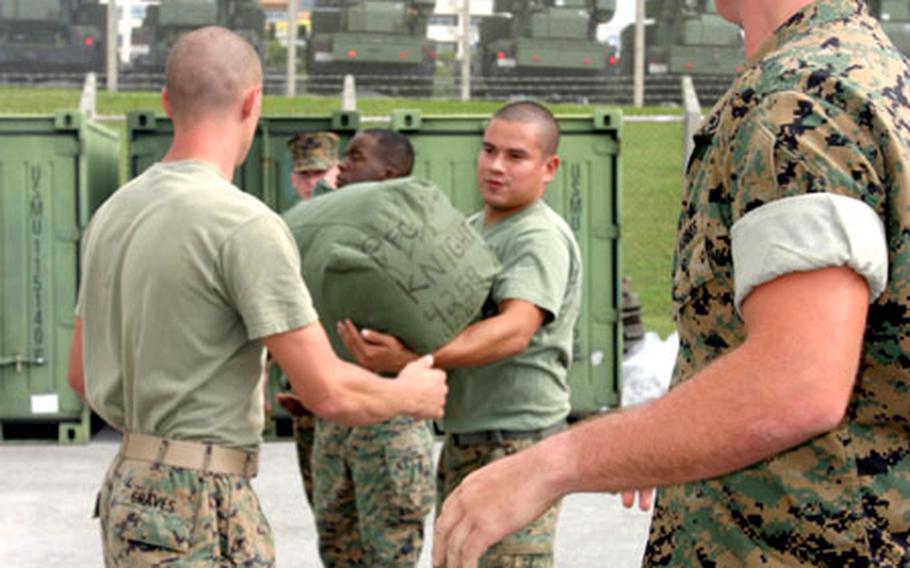 Marines from 1st Stinger Battery, 1st Marine Aircraft Wing move sea bags last week to prepare for a deployment to Wake Island.