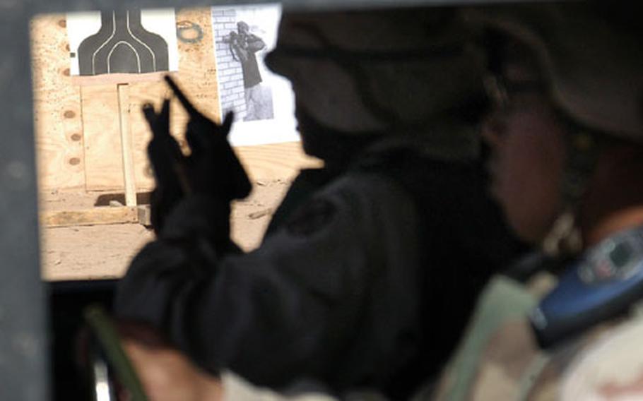 Staff Sgt. Deion Toney, with the 302nd Transportation Company, prepares to return fire after her convoy was “attacked” during a live-fire simulation at Logistics Support Area Anaconda, Iraq.