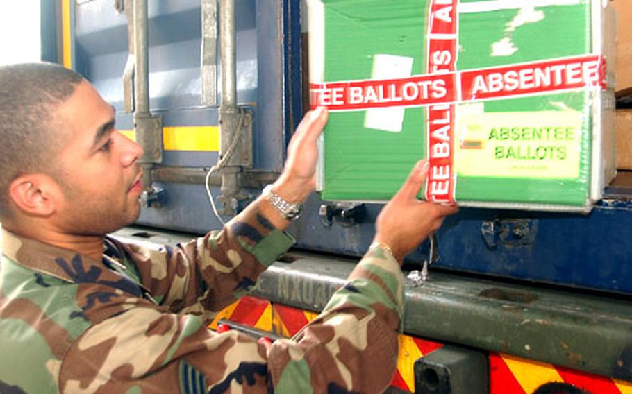 Senior Airman Ted Braxton, a postal clerk, loads a box containing absentee ballots onto a truck at the Rhein-Main Air Base, Germany, post office on Tuesday.
