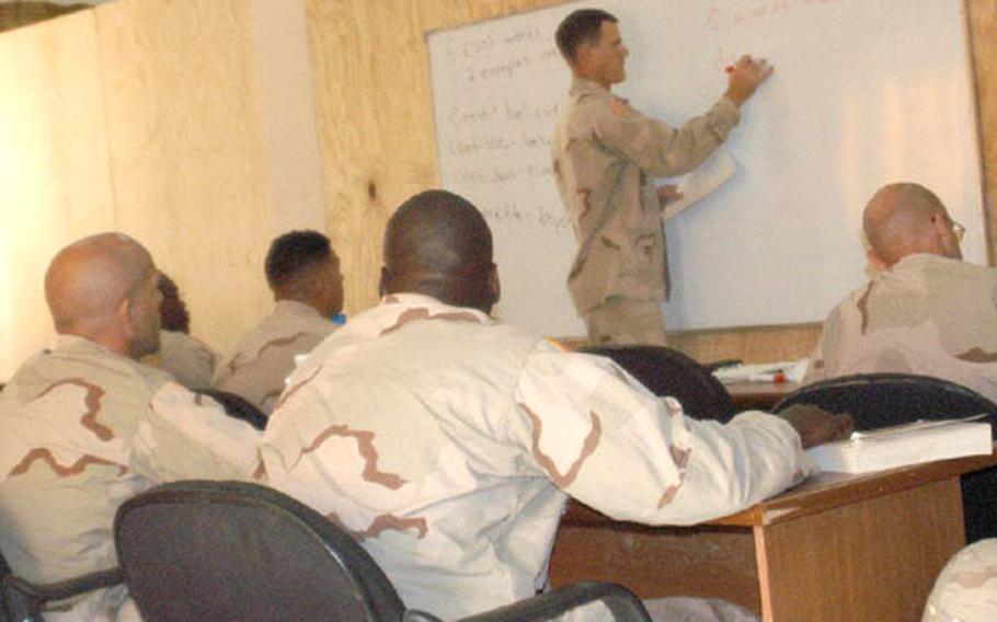 Staff Sgt. Thomas Barnhart, education center NCO-in-charge, teaches an Armed Services Vocational Aptitude Battery class in the center, which is currently under construction.
