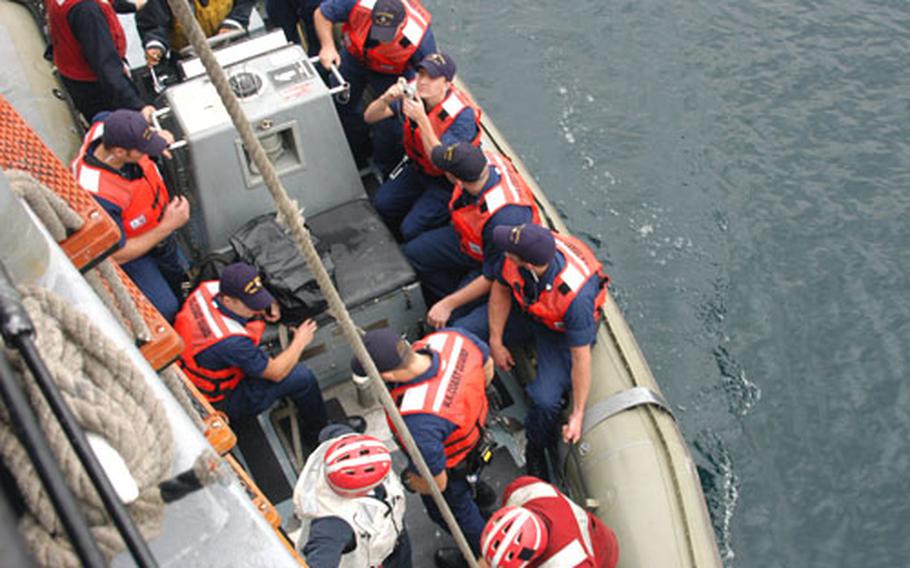 A Coast Guard law enforcement team from Alameda, Calif., prepare to leave the USS Vandegrift to zip over and board a Japanese ship pretending to carry weapons of mass destruction in Tuesday’s exercise under the Proliferation Security Initiative. The training was held in Sagami Bay, north of Yokosuka Naval Base, Japan.