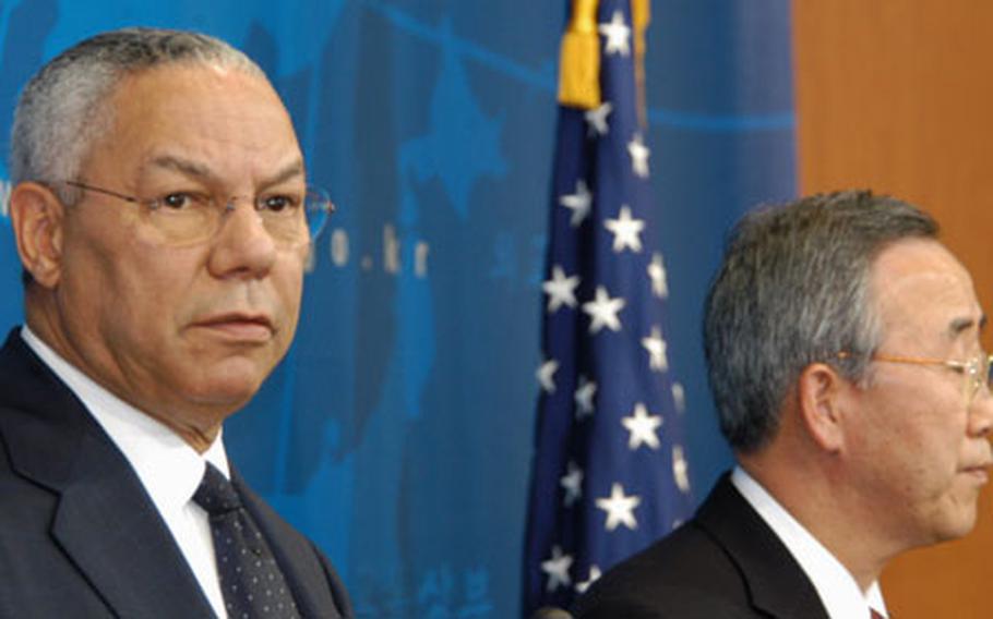 U.S. Secretary of State Colin Powell, left, and Korean Foreign Minister Ban Ki-moon take questions during a press conference in Seoul on Tuesday.