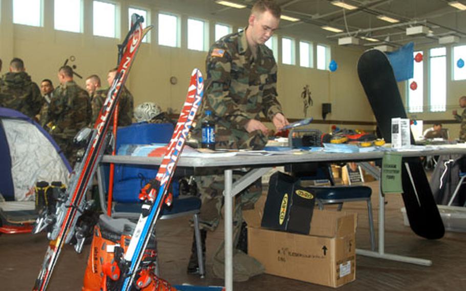 Spc. Jeremiah Prine, with the 19th Support Center, 13th Corps Support Command, helps with the Outdoor Recreation booth during the Expo Wednesday. Prine was recently named the 221st Base Support Battalion volunteer of the quarter by Outdoor Tec.