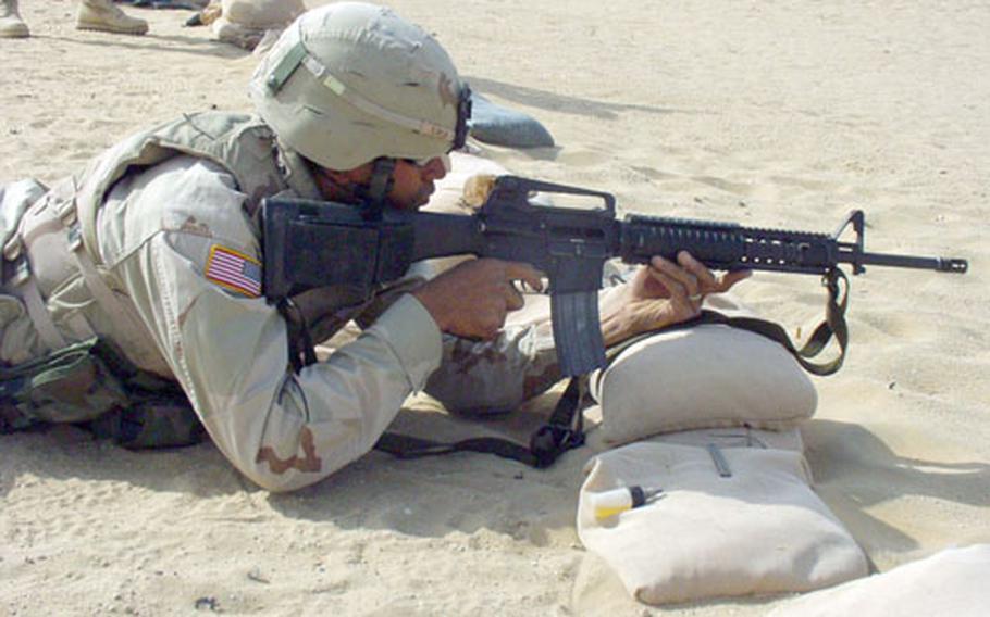 Spc. Joseph Barnaba, 30, of Opelousas, La., fires his M-16 at the remote Udairi Range in the desert of northwestern Kuwait. His unit, the 256th Brigade Combat Team of the Louisiana National Guard, is training for duty in Iraq. It is the first unit of the third wave of troops to serve in Iraq in what is being called Operation Iraqi Freedom ’04-’06.
